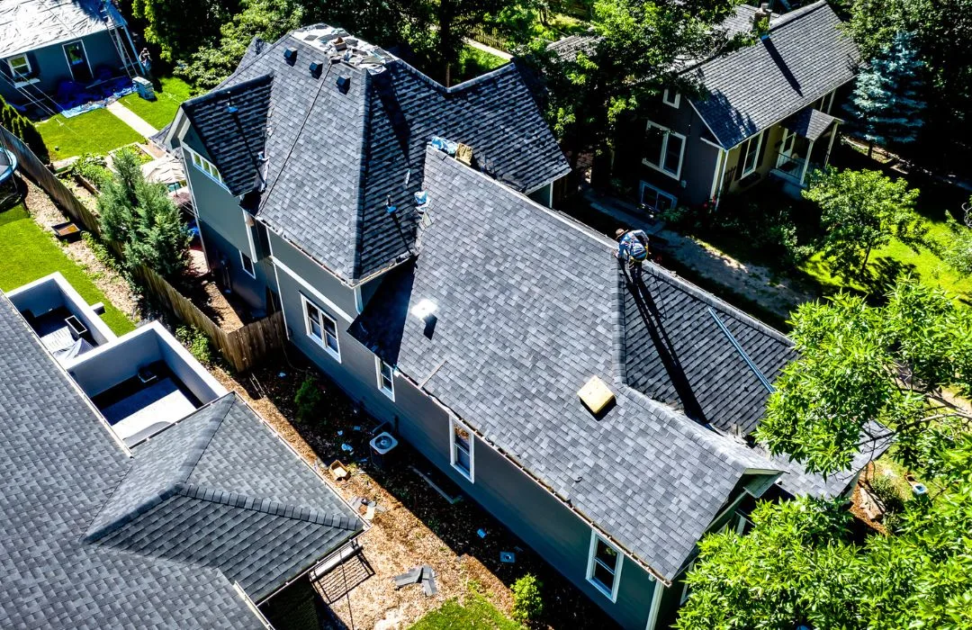 workers on old town house Aerial view of a residential roof